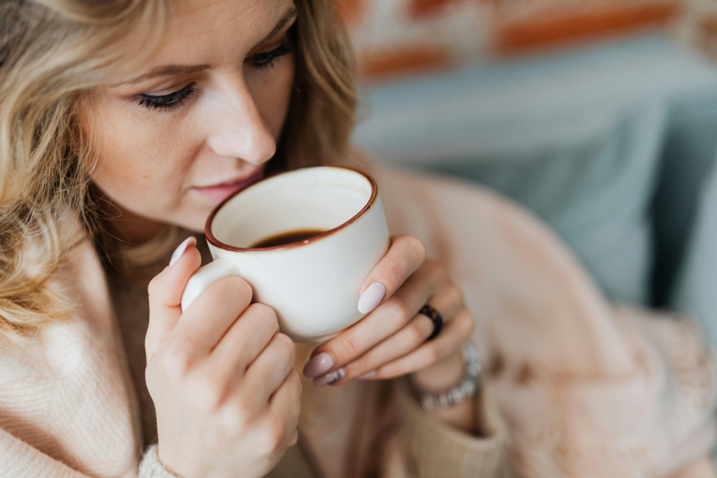 a woman drinking warm anti-aging drink